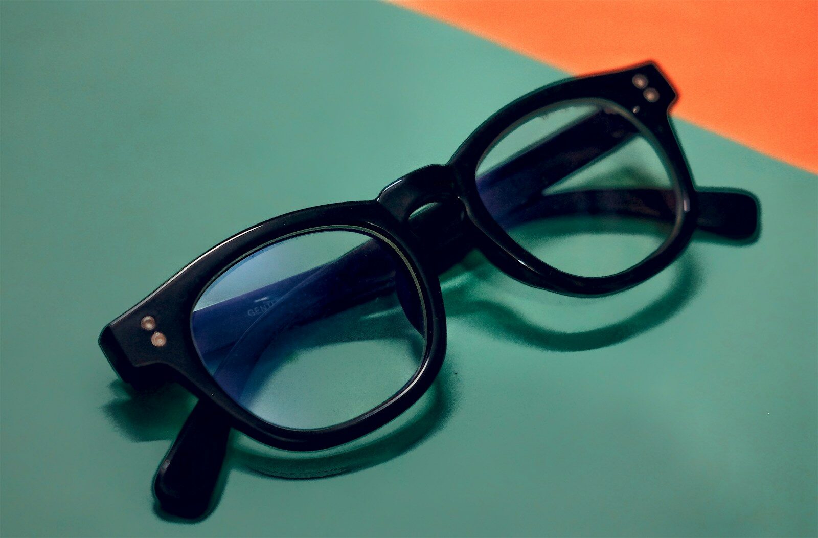 a pair of glasses sitting on top of a table